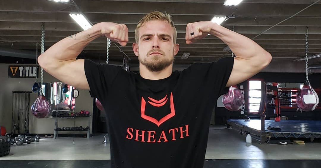 Photo of MMA fighter Dylan King wearing a SHEATH shirt