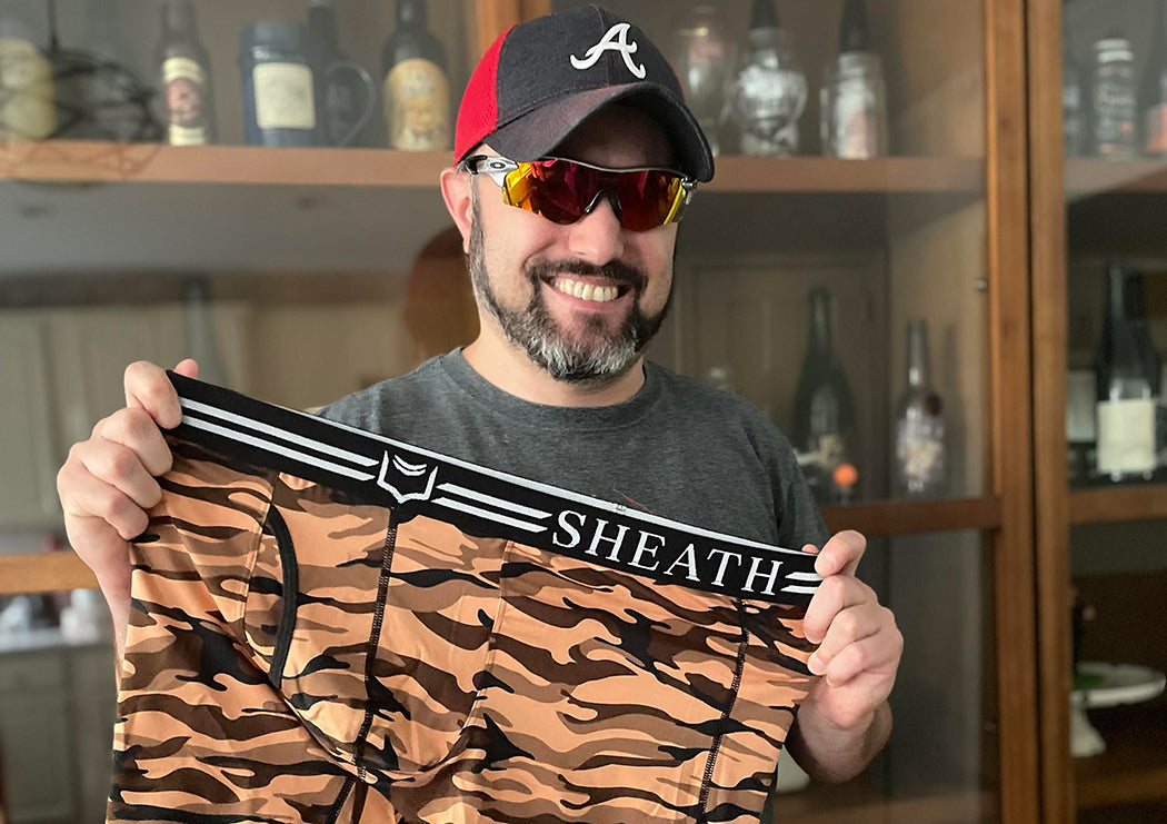 JD from NY holding a pair sheath red camo