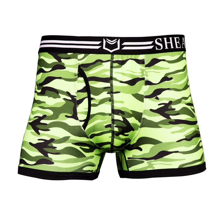 SHEATH trunks in green camo pattern featuring dual pouch support, breathable polyester fabric, ergonomic fit, anti-chafing design, and a branded elastic waistband. front view#color_forest-green