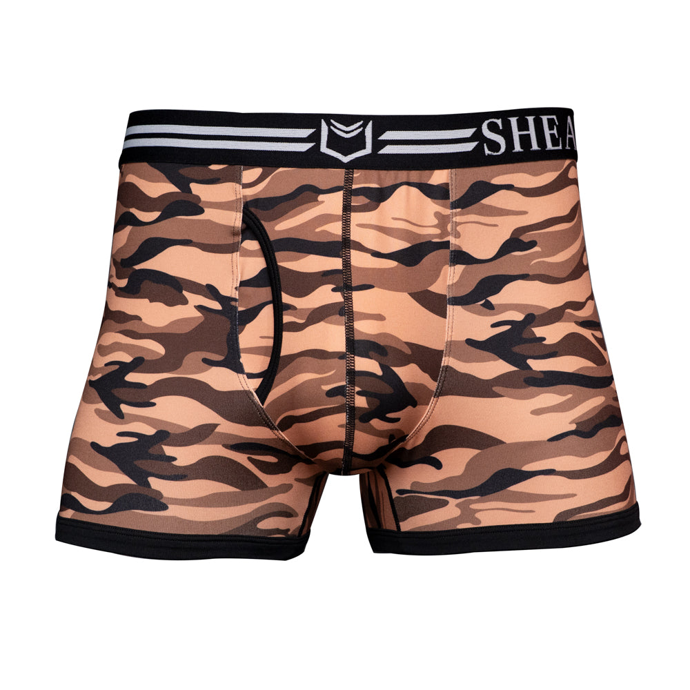Men's trunks in red and black camouflage pattern, featuring ergonomic dual pouch design, breathable moisture-wicking fabric, and black waistband with white stripes and logo.#color_desert-red